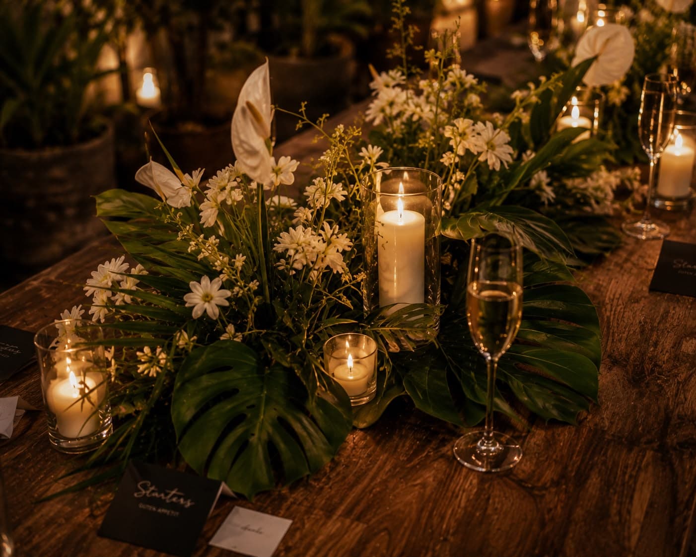 Candlelit table with white flowers and champagne glasses